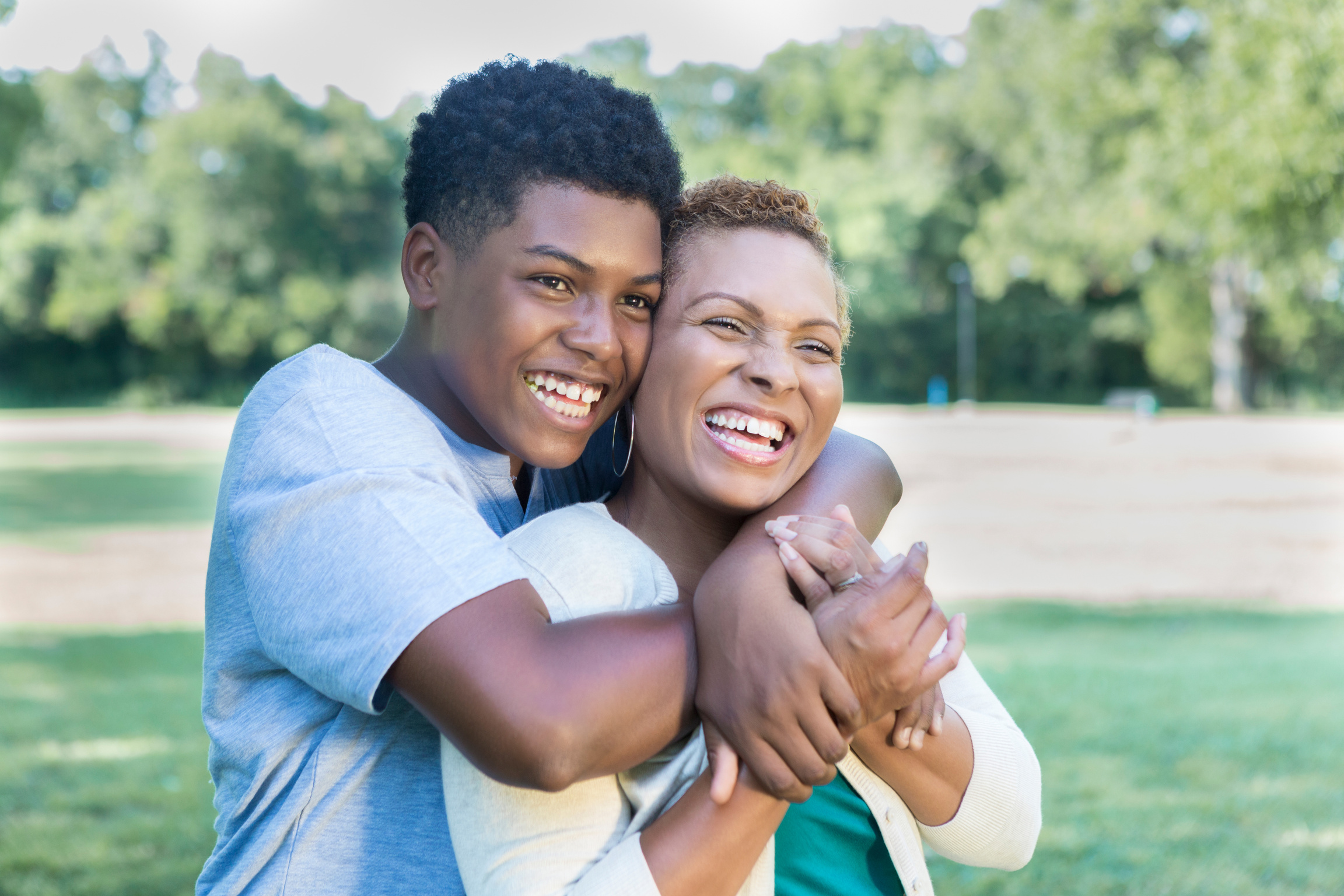 Teenage son hugs his mom