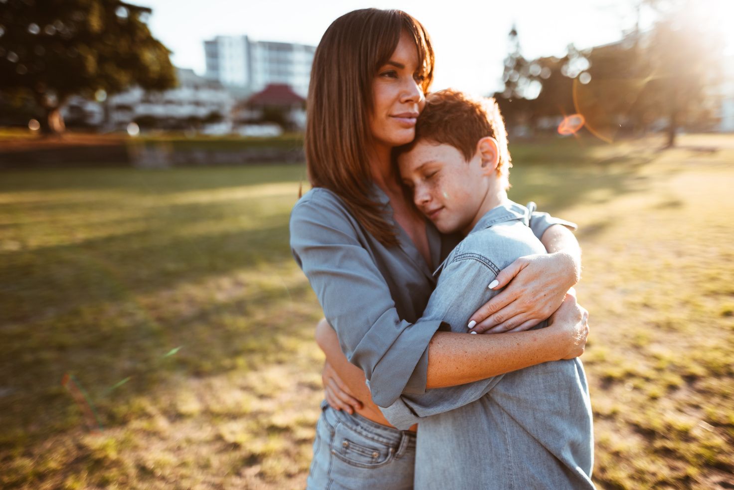 teenager embraced with mom consoling her son